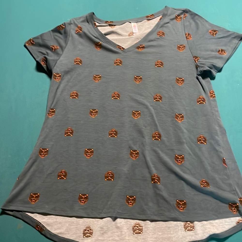 LuLaroe shirt with wildcard on it and a blue grey background short sleeve